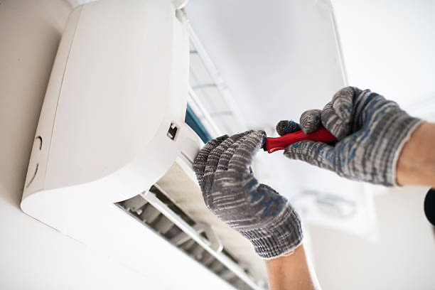 Technician diagnosing and repairing an AC unit