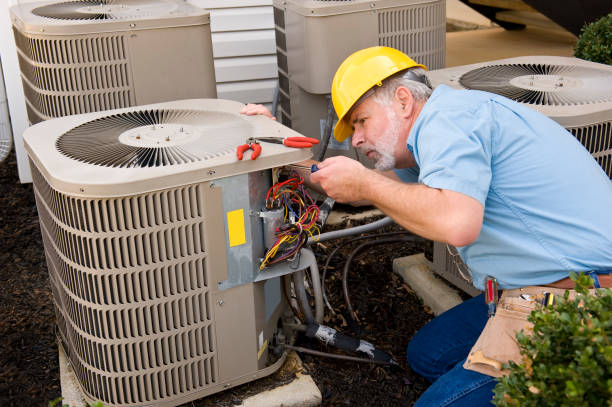 Technician repairing a heavy-duty cooling system compressor