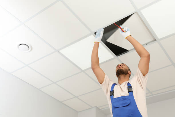 Worker repairing a ceiling during a home renovation