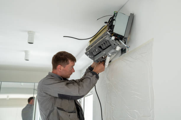 Technician drilling during a new AC unit installation outdoors