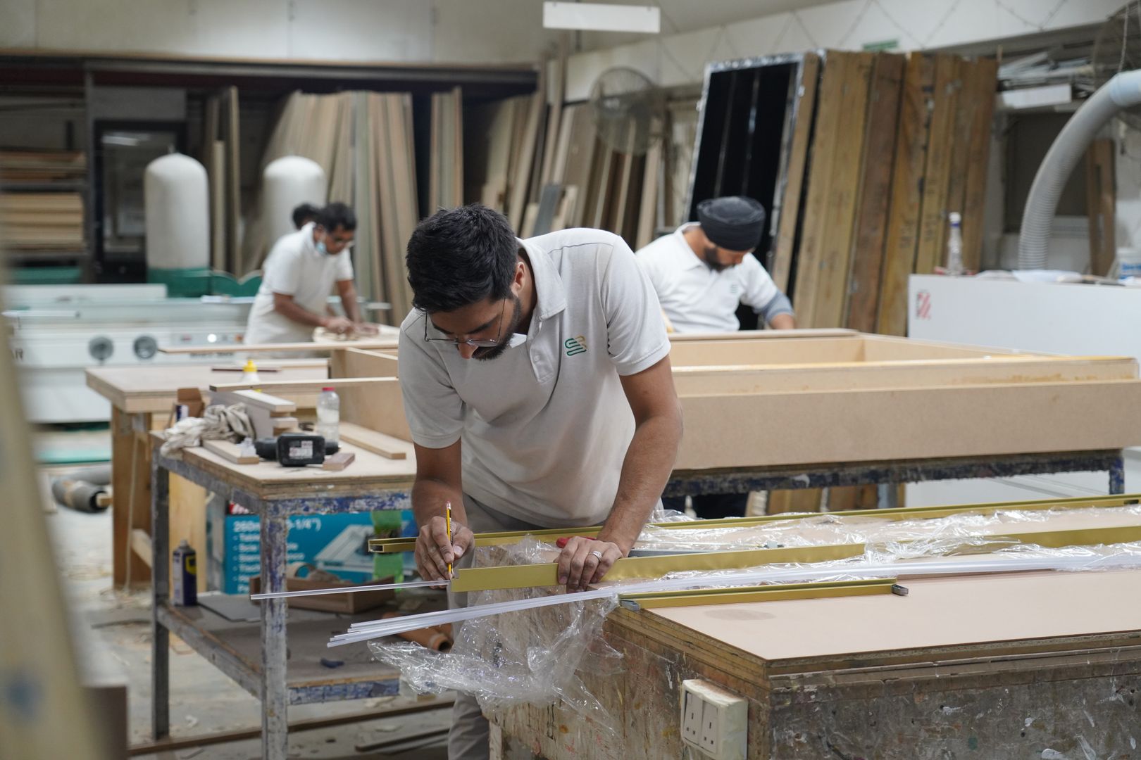 Carpenters at work in a Dubai joinery workshop