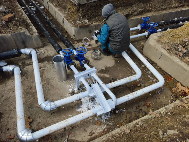 Plumber installing new pipework with professional tools