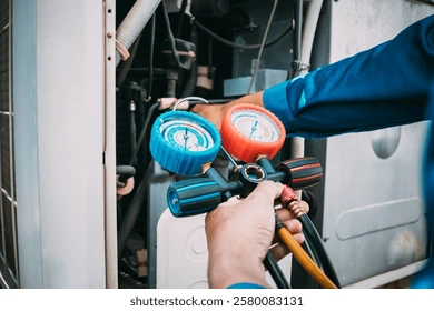 Technician tracing a refrigerant leak inside an AC unit